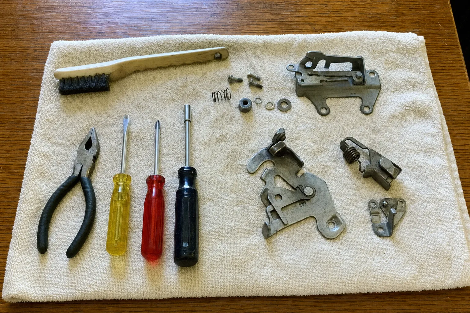 Replacement latch and hinge assemblies set out beside the tools used to fit them